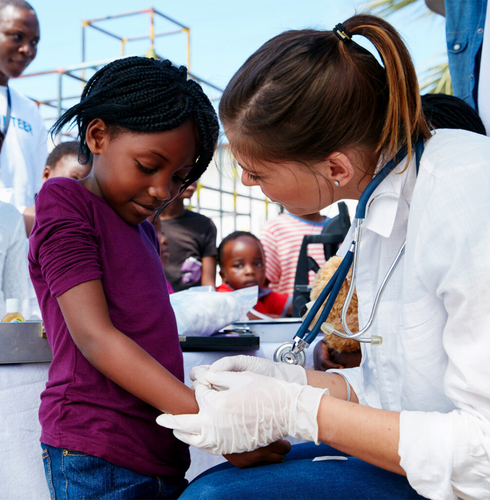 Cropped shot of volunteer nurse giving checkups to kids