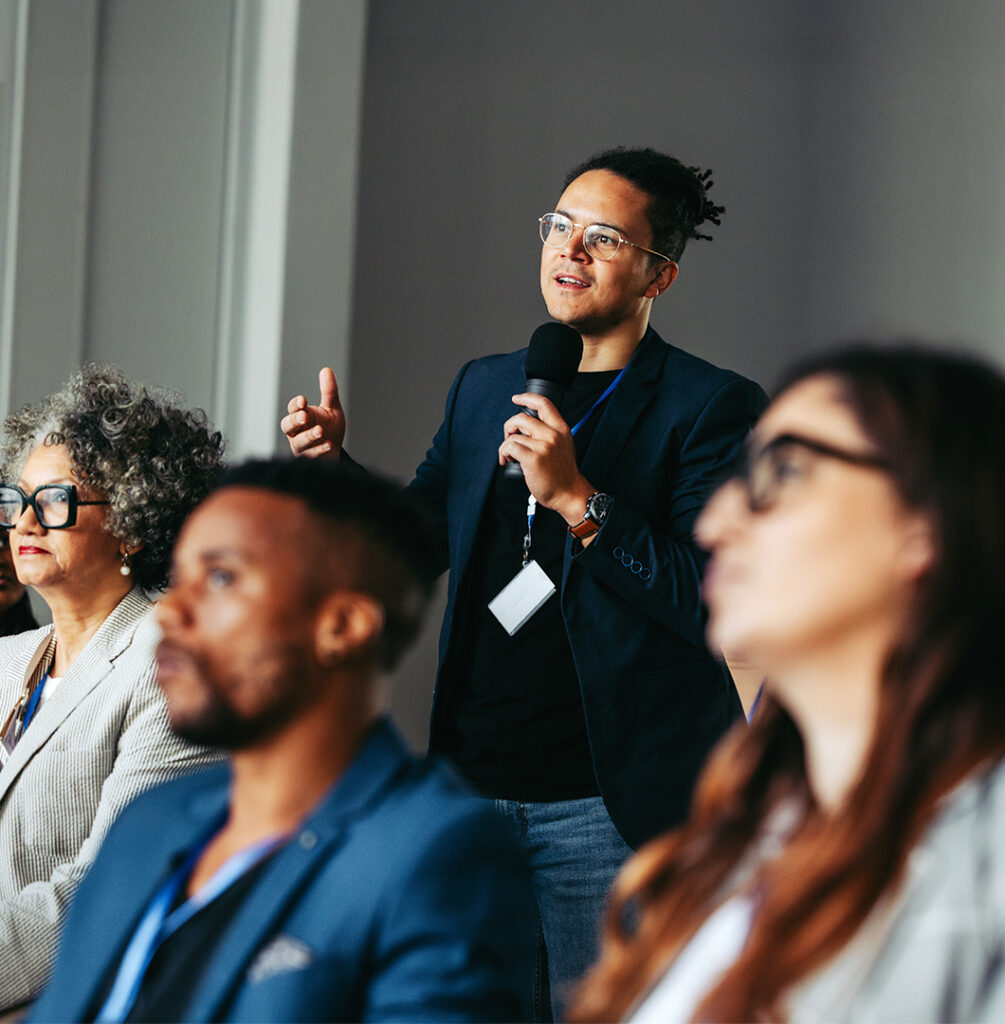 Businessman asking question during presentation